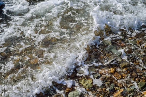 Fototapeta Waves at the seashore. Selective focus with shallow depth of field.