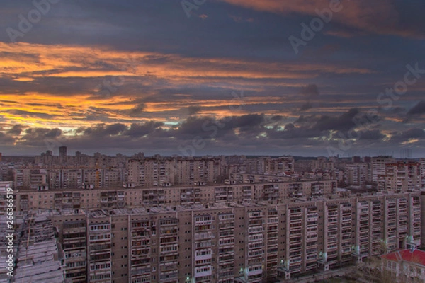 Obraz Sunset clouds over the city