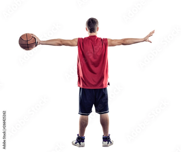 Obraz Basketball player standing back to camera with ball in hand isolated on white background