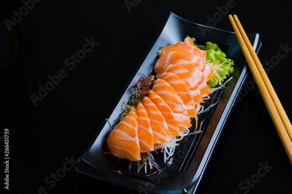 Obraz Salmon Sashimi on Black Ceramic Plat,black background.