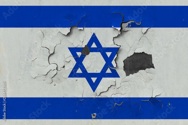Fototapeta Close up grungy, damaged and weathered Israel flag on wall peeling off paint to see inside surface.