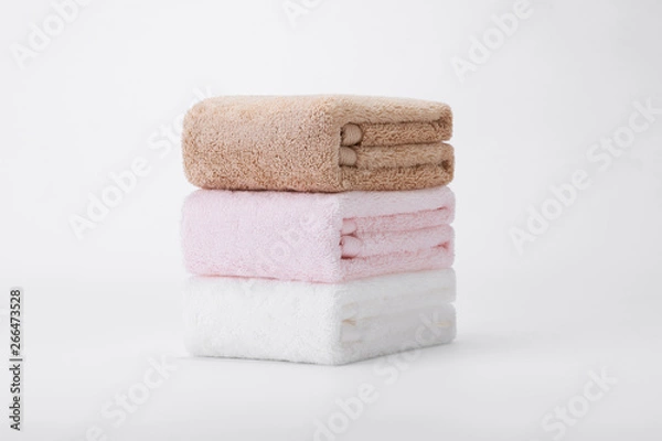 Fototapeta Stacked white, pink, apricot towels