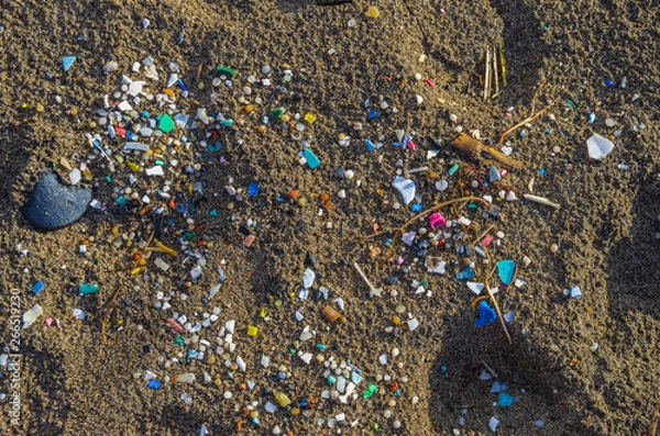 Fototapeta Micro plastics mixed in the sand of the beach