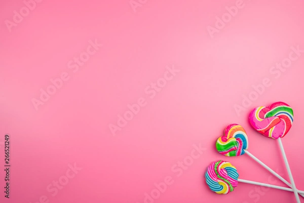 Obraz Multicolored lollipops on a pink background