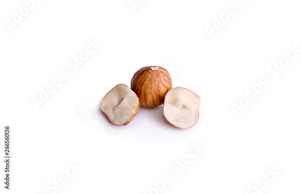 Fototapeta peeled hazelnut in a cut on a white background
