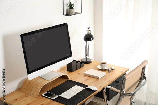Fototapeta Stylish workplace interior with modern computer on table. Mockup for design