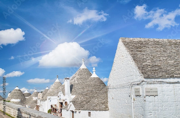 Fototapeta Alberobello, Apulia - Italy. Beatiful view of Trulli against a blue summer sky
