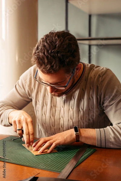 Obraz Leather craftsman working with natural leather. Handmade concept. Concept of small business to create leather products.