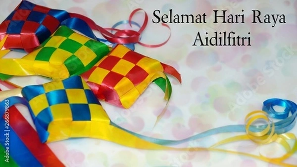 Obraz Greeting with malay word "Selamat Hari Raya Aidilfitri" that translates to wishing you a joyous hari raya on ketupat ribbon background. Selected focus. Image flare, soft, bokeh and vintage.