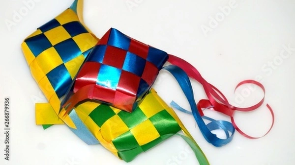 Fototapeta Ketupat ribbon in white background / Origin of Ketupat - A traditional rice wrapped by leaf and to be consume at the period of Hari Raya.(selective focus and soft focus).