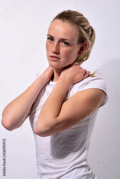 Obraz portrait of a young beautiful girl with blue eyes and freckles on a white background
