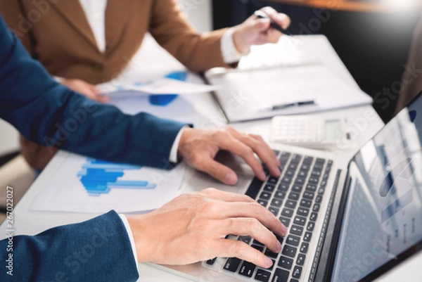 Fototapeta teamwork company meeting concept, business partners working with laptop computer together analyzing startup financial project result or strategy plan and discussing data document in office.