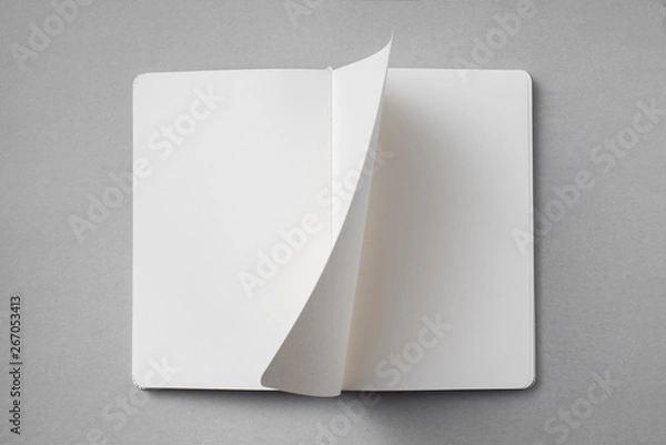 Obraz white notebook with turn page on grey background