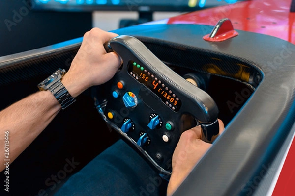 Fototapeta Man playing a racing video game - driving f1 simulator