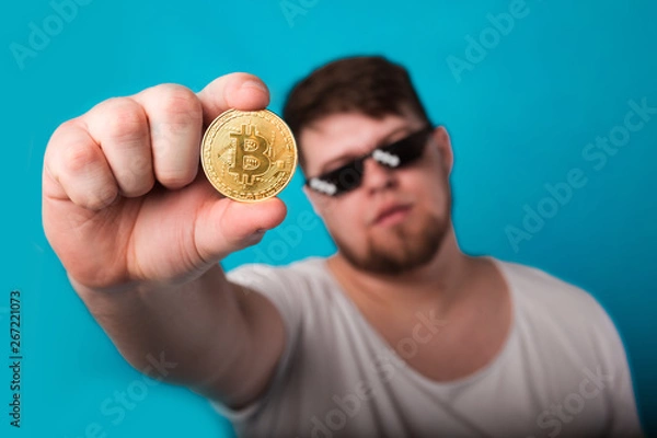 Fototapeta cool guy with a coin in his hand