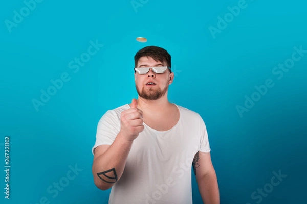 Obraz man throws up a coin