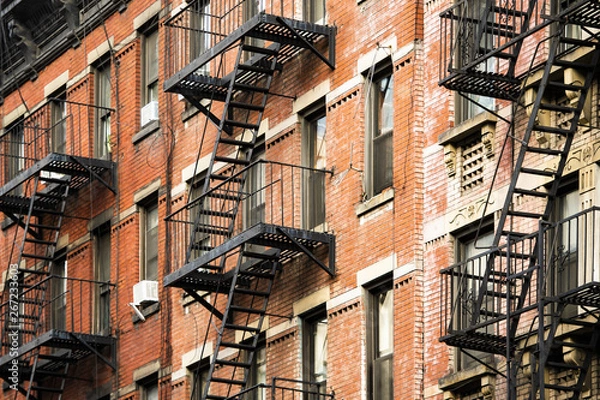 Fototapeta Close-up view of New York City style apartment buildings with emergency stairs along Mott Street in Chinatown neighborhood of Manhattan, New York, United States.