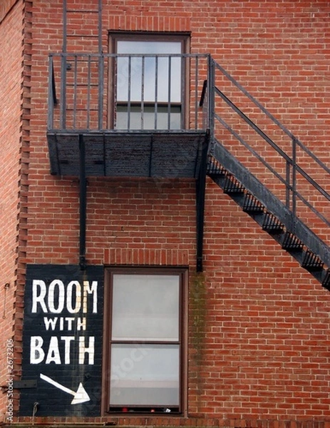 Obraz fire escape and "room with bath" sign