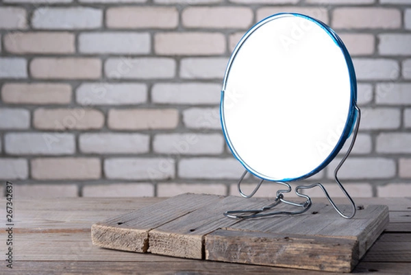 Obraz Desktop mirror on the table with a brick background