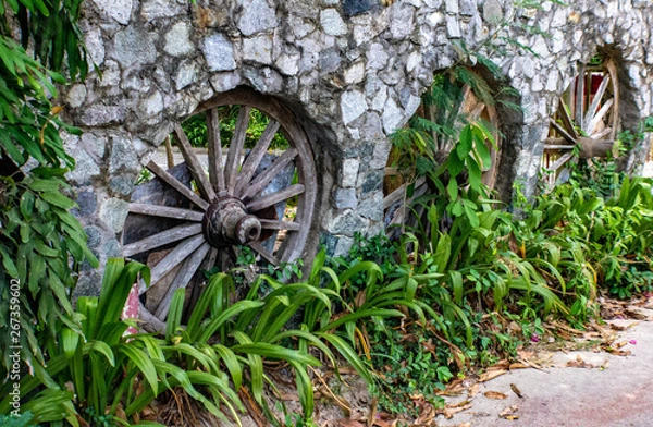 Obraz Three cartwheels in a stone wall