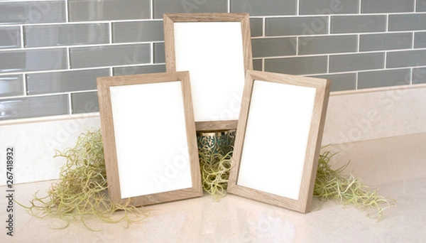 Fototapeta Three 5x7 natural wood picture frames with green moss and a tiled background