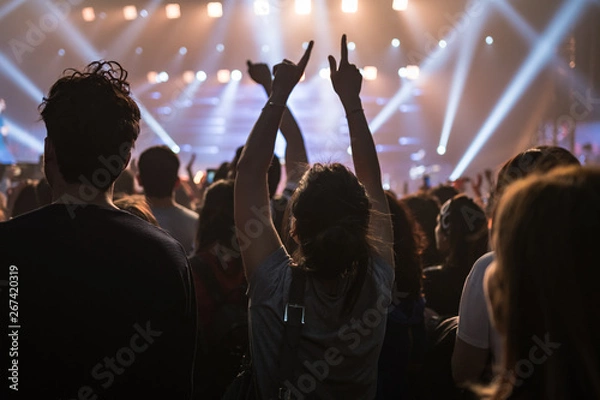 Fototapeta hands to the skies of people dancing and having fun at the live music concert