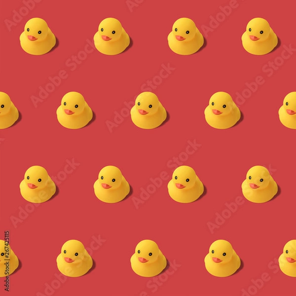Fototapeta repeatable pattern of yellow rubber duck on red background Modern style. creative photography.