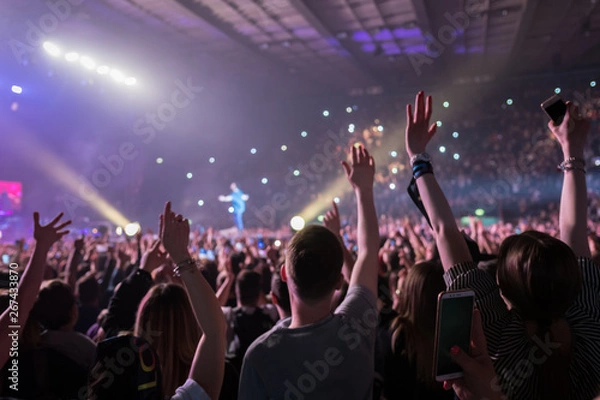 Fototapeta hands to the skies of people dancing and having fun at the live music concert