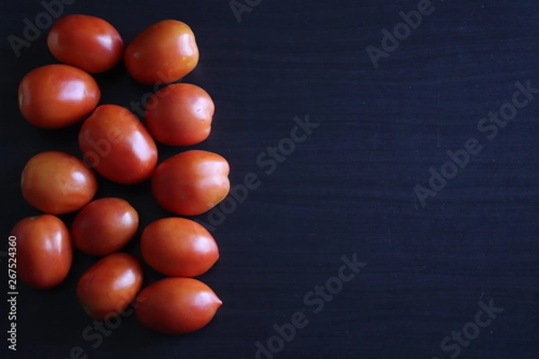 Obraz raw vegetables on a dark table