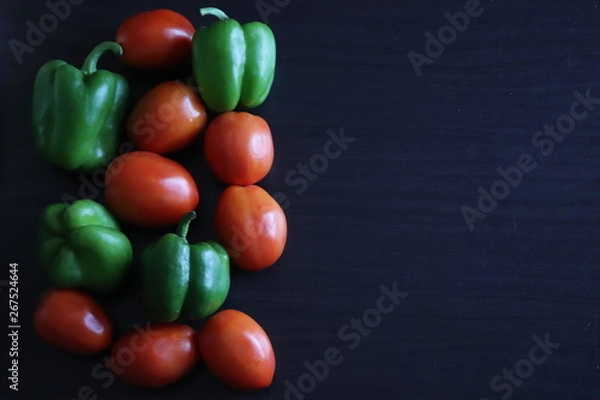 Obraz raw vegetables on a dark table