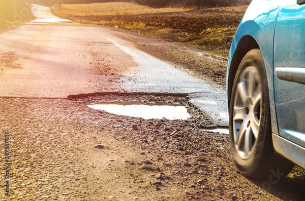 Obraz Car and winter pothole on open road