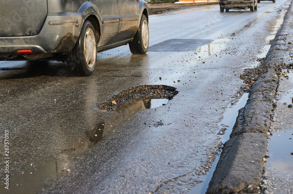 Obraz Big pothole on road after winter