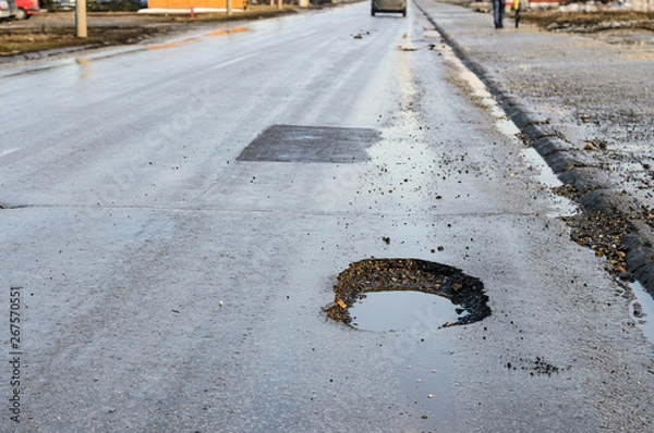 Obraz Big pothole on road after winter