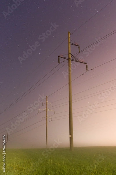 Fototapeta electric pole at night in the fog