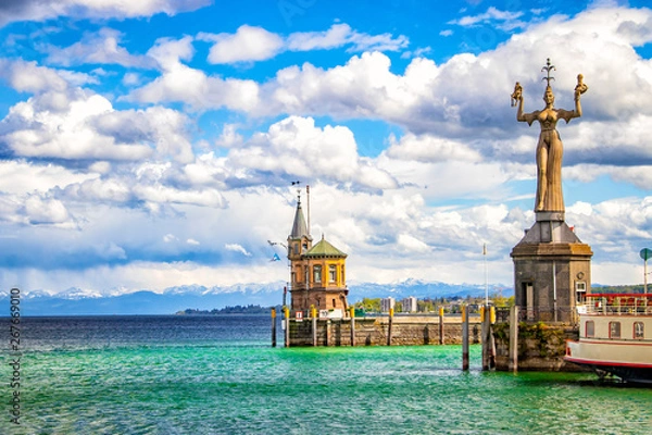 Fototapeta The city Constance on the Lake Constace, Bodensee. The view from the ship on the port with big statue and lighthouse. The city lies in Germany and Switzerland.