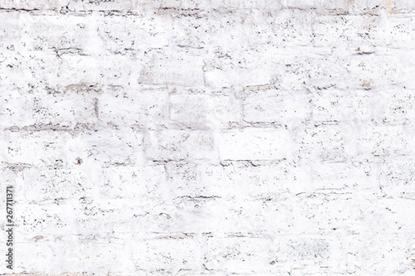 Obraz plastered brick wall with whitewash,with sloppy brick and crumbling whitewash,taken on a Sunny spring day