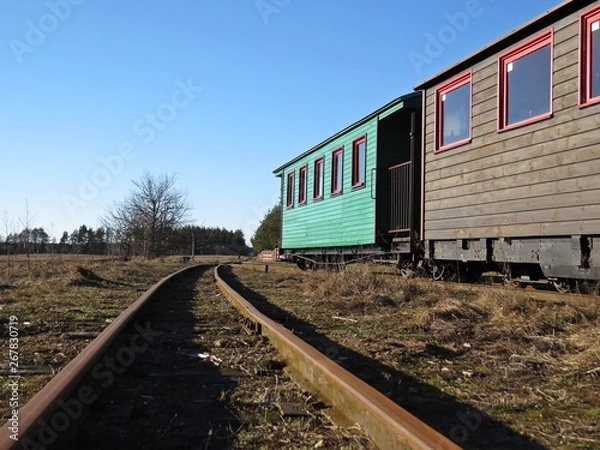 Obraz Narrow Gauge Railroad Train Railways Detail Perspective during Day with Historical Colorful Carriages Coaches