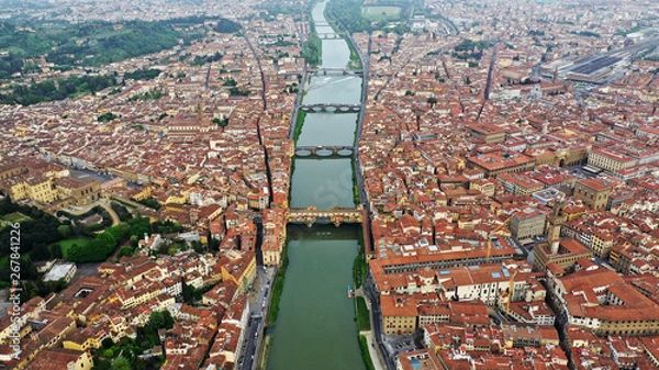 Fototapeta Aerial view of Ponte Vecchio bridge on Arno river in Florence city center, Italy. Italian orange roofs from drone near Cathedral. Tuscany.