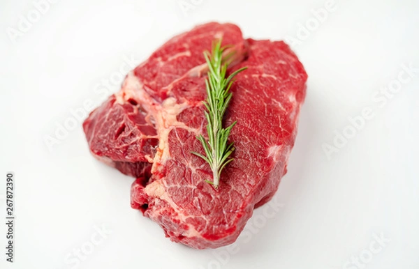 Obraz raw beef steak with herbs and spices on a white background, isolate
