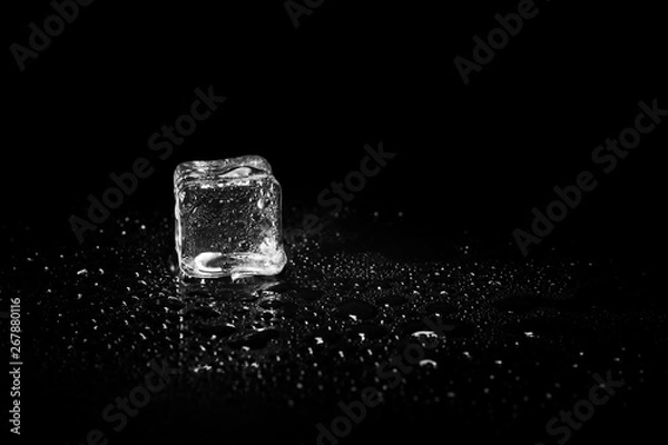 Fototapeta ice cubes reflection on black table background.