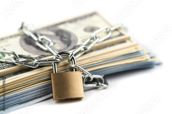 Obraz Business safety or financial protection or restriction access. Heap of money in chain with padlock isolated on white