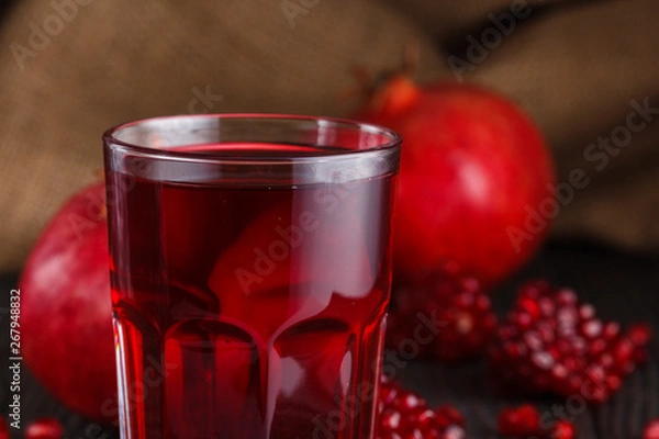Fototapeta grains of a grenade on a dark rustic background