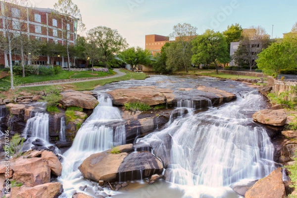 Obraz View at Greenville downtown waterfall in Falls park from the hanging Liberty bridge. Beautiful, powerful and very attractive for visitors.