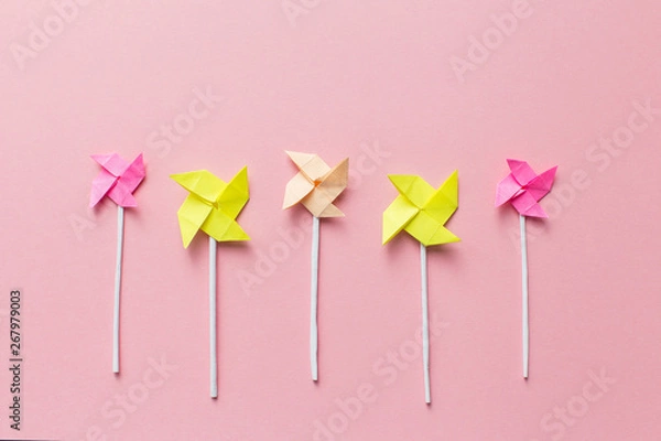 Fototapeta Windmills of paper on pink background, handmade, origami