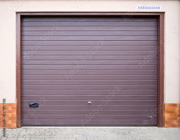 Fototapeta The entrance to the garage is equipped with a roller shutter gate.