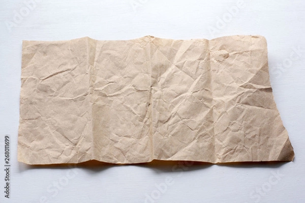 Fototapeta A piece of crumpled paper on a light background.