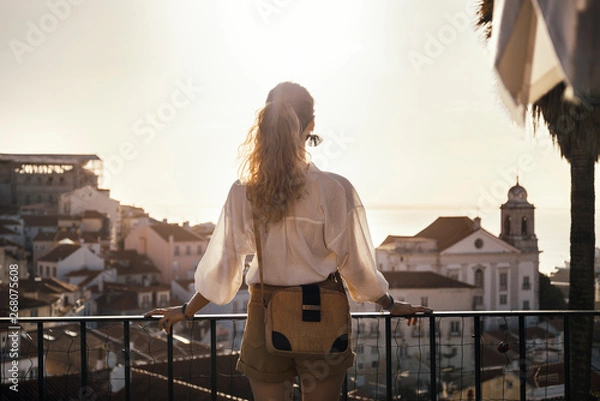 Obraz young woman wearing vintage clothing exploring Lisbon on the balcony view point in Alfama