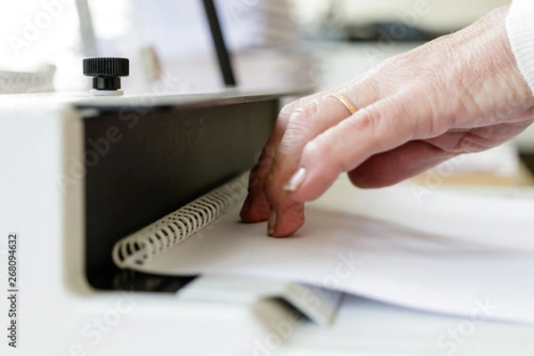 Fototapeta Book Binding Machine Operator. Work with Book binding machine.