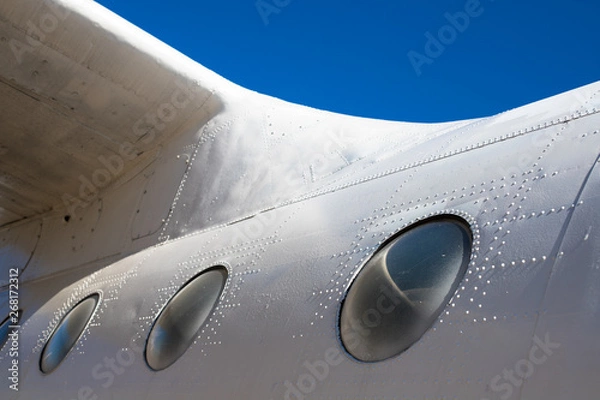 Obraz Fuselage cabin. Part of the aircraft. The body of the aircraft against the blue sky.