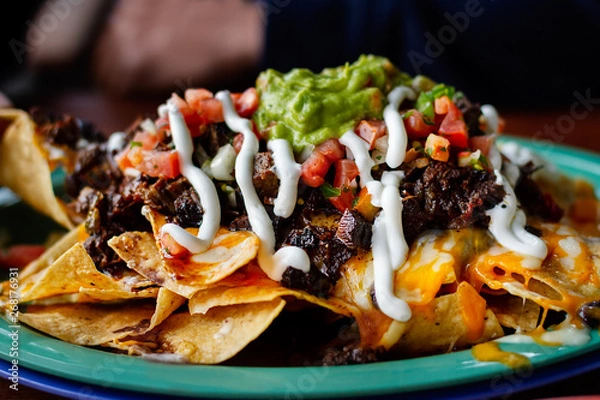 Obraz Beef and cheese corn nachos served on a big plate ready to eat